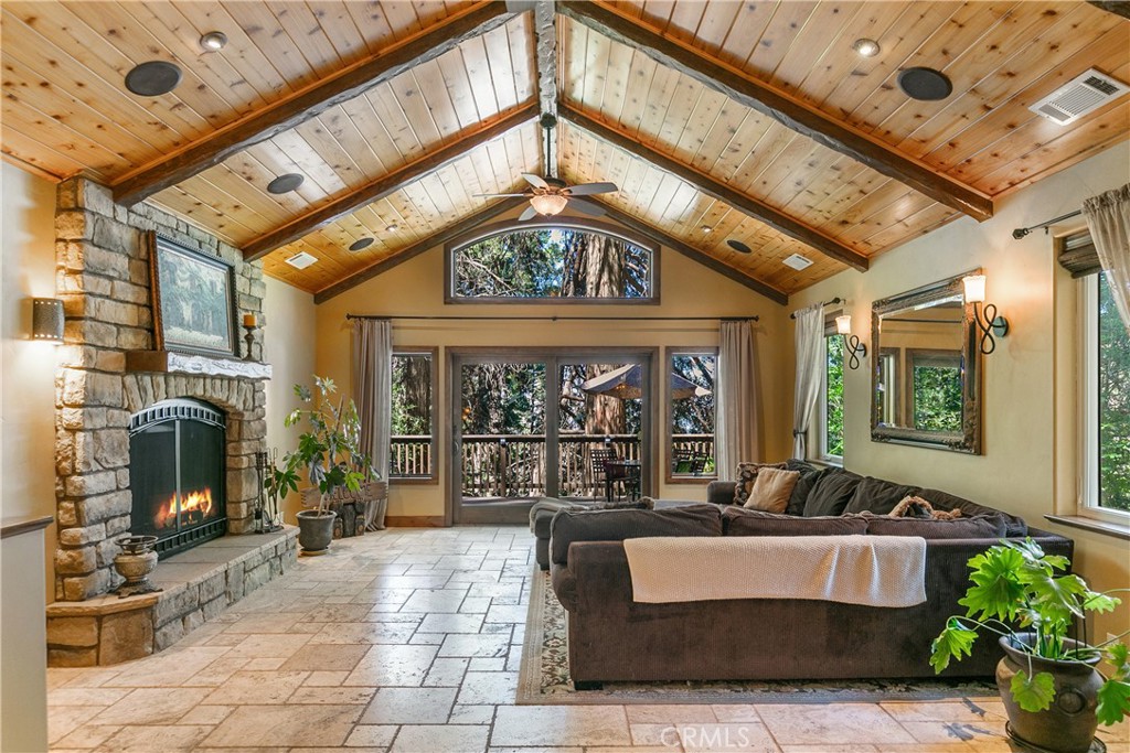Mountain Elegance!
Welcome to your dream retreat in beautiful Crestline—rebuilt in 2012 with no expense spared and meticulously maintained ever since. This stunning home offers the perfect blend of timeless mountain charm and thoughtful modern upgrades.
Step inside to a warm formal living room centered around the original fireplace, then flow seamlessly into the heart of the home: a chef’s kitchen featuring leathered granite countertops, walk-in pantry, breakfast bar, and custom banquette seating—designed for entertaining. The expansive family room showcases 16-foot cedar ceilings, exposed wood beams, and a majestic stone fireplace with a wooden hearth, creating a picture-perfect setting for holidays or cozy nights in. Double pane sliding doors lead to a spacious Trex deck, ideal for outdoor dining and entertaining.
The main level includes a private bedroom with its own Trex deck, while downstairs you’ll find two additional bedrooms, including a luxurious primary suite with an ensuite bath, private deck with spa, and a cozy Heatilator fireplace—perfect for relaxing on chilly mountain evenings. The lower level also includes a convenient mudroom/laundry area and additional outdoor seating space.
Beyond beauty, this home was built to last—with Class A fire-rated fiber cement board siding for peace of mind, custom wrought iron fencing and railings that add both style and security, and a whole-house Generac generator to ensure uninterrupted comfort no matter the season.
Additional perks include a level-entry one-car garage, generous off-street parking for up to five vehicles and an easy commuter location.
Located Conveniently 5 Minutes away from Lake Gregory. Crestline offers a true mountain lifestyle with a public lake, scenic walking trail, summer water activities, a dog park, and festive parades that bring the community together all year long.