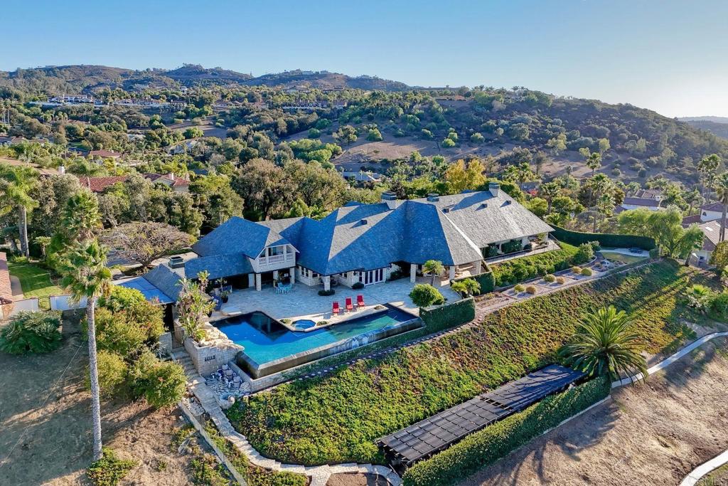 REDUCED $221,000! Excellent opportunity to own this beautifully designed luxurious custom built estate offering the finest in resort style living! Highly desirable gated community in beautiful Bonsall! Bonsall schools. Enjoy gentle ocean breezes & spectacular sunset views from your own 2.5 acre parklike setting! Superior construction & high quality craftsmanship. Grand Porto Cochere entry & circular stone driveway with parking for 10+ vehicles. Very private parklike setting with lush landscape & turf. Numerous expansive indoor & outdoor entertaining spaces for large family gatherings & holidays. Very open floorplan with views from every window! Vaulted, open beam, recessed, coiffured & dome ceilings-this exquisite home has it all! Stunning library with wainscot, custom book shelves & grand corner fireplace. 5 total fireplaces & 7 bathrooms. High end chef's kitchen appliances & island with bar seating. Primary bedroom ensuite features a 2 sided fireplace, room sized closet/dressing room, wet bar, private laundry room, 2 verandas with spa & dry sauna & a private upstairs loft-ideal for office/gym. 3 bedroom ensuites are located on the private west wing of the home. An additional spacious loft style ensuite is located on the opposite end of the home with full bath, closet, private stairway & balcony-perfect for multi-generational family, guests, game room or staff. Vanishing edge salt water pool with 60'x12' lap pool adjoining 20'x25' deep water with diving rock & waterfall. Outdoor fireplace, kitchen, wet bar, veranda & pool bathroom with shower. Other features include solar for home & pool, security system & custom cabinetry throughout. This is an exceptional home with an an abundance of upgrades/detailed list of home features attached in documents. Highly desirable Bonsall school district. Selective furnishings may be negotiable. Seller may carry a note for qualified buyer with substantial down payment.