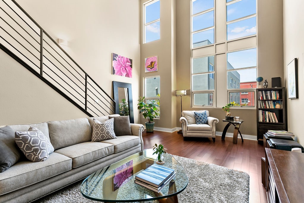 RARE PREMIER LOCATION! One of a kind for this community - Upgrades GALORE!! This charming unit is located in the HIGHLY desirable, private inner-courtyard location at the Santiago Street Lofts - 100% Live/Work Lofts. This Flexible plan 2 offers 1 Master Bedroom + 1 Optional Bedroom, 2.5 Baths, 2 Car Attached Garage SIDE BY SIDE & large Gallery/Office Space w/ bathroom. The sprawling living space w/ 20' ceilings, exposed ducting, industrial finishes, enormous windows for natural light & engineered scalloped walnut stained wood floor throughout. Brand NEW remodeled kitchen left nothing untouched, featuring stainless steel appliances, under counter water filtration system, doubled the cabinet & counter space for this floor plan + MORE. A full 2nd bathroom on the 2nd floor w/ custom tile floor and walk-in shower. Also on the 2nd floor is the stacked washer & dryer & spacious dining room. The 3rd level has an add'l loft space, perfect for a second bedroom or office space. The secluded master bedroom is plenty big w/ sliding doors on the closet and custom built in closet organizers. On the ground floor, the gallery - enjoy the immense detail from FLOOR to CEILING, brand new mini split AC (2022), Daikon heat pump (energy efficient and extremely quiet), 1/2 bathroom and roll up industrial door. Add'l upgrades throughout: cellular shades in dining and bedroom, ceiling fans, custom brand new paint, light fixtures, LED recessed lighting +more. Less than 1 mi to DTSA, the OC Streetcar to whiz you downtown for its diverse dining and entertainment. Connections to LA and SD just across the street via Amtrak, MetroRail, & Pacific Surfliner. Hurry, this beautiful home won't last long!!