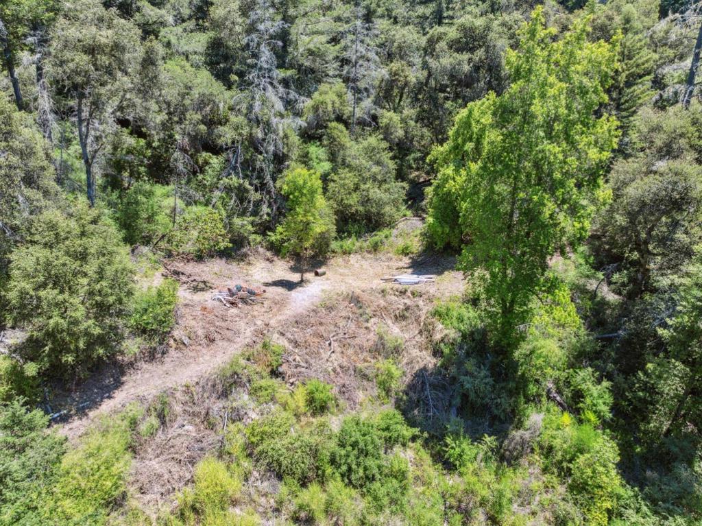 For decades, this 31-acre property has been a cherished recreational escape for one family, now it is ready for its next chapter. Located along scenic Deer Creek Road, the land offers a mix of sunny ridge tops, shady forest, and serene creek frontage. Per the owner, the property starts before the second bridge and both Deer Creek and Bear Creek flow on the property and typically run year round. Recently, the owner had the brush cleared along the old driveway leading to the family's longtime trailer site. The trailer remains but is in poor condition, awaiting either restoration or removal. Turnouts along the road provide convenient parking, with trails and old roads leading up to several flat, sunlit areas perfect for picnics, camping, or future projects. The property's TP (Timber Production) zoning offers significant tax savings approximately one-tenth of the standard 1.2% property tax rate making it an attractive investment for timber management or long-term ownership. Whether you are seeking a weekend getaway, a private camping spot, or a large tract of timberland with mountain views, this rare offering combines seclusion, natural beauty, and potential.