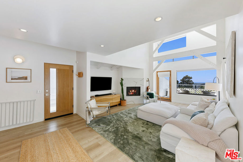 Incredible private Malibu retreat nestled in the hills of El Nido, just minutes from the beach. This stylish home blends modern architecture with warmth and natural light. Vaulted ceilings, exposed beams, and expansive windows frame breathtaking ocean and mountain views. The open living area flows effortlessly from the cozy fireplace to a sunlit patio, perfect for lounging and entertaining. The chef's kitchen features new appliances, a center island and skylights that bring the outdoors in. The serene primary suite offers dual closets and a beautifully renovated en-suite bath. Two additional bedrooms provide flexibility for guests, a home office, or a nursery. A separate bonus room makes the perfect private office or creative space. Outside, enjoy peaceful garden spaces, a hammock strung between palms, and a private spa with hillside views. Located just minutes to Malibu's best beaches, hiking and dining.