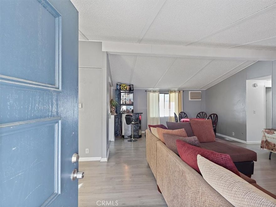 Welcome to one of the most desirable gated communities in Palmdale! This beautifully updated 3-bedroom, 2-bathroom home combines comfort and serenity. Located in a secure, well-maintained neighborhood near schools, shopping, and dining. Step inside to discover flooring throughout and a bright, spacious kitchen with spacious cabinets, sleek countertops, and big windows that fill the space with natural light. The inviting living room is perfect for relaxing evenings at home. Some lighting has been upgraded, adding both convenience and efficiency. You will also have access to resort-style amenities, including two community pools, spa, gym, and community kitchen and huge recreation room for parties, games, a fun play area for the kids. Experience the security and lifestyle of gated living while still being just minutes from everyday conveniences. Do not miss out on this one-of-a-kind place to call home!