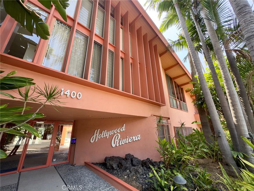 A rare opportunity to own a true piece of Los Angeles architectural history at the legendary Hollywood Riviera, designed in 1954 by Edward Fickett, renowned leader of modernism. This unit features the authentic mid-century amenities, including signature beamed ceilings, paneled walls, and green-toned concrete floors that echo the era’s minimalist modernism.Perched on the top floor, this west-sunset facing unit is flooded with natural light with oversized floor-to-ceiling windows offering views of lush greenery and the building’s bold mid-century lines. Includes a classic bathroom with tiled shower/tub combo, and a spacious living room perfect for showcasing your modernist aesthetic.The open-concept layout is rarely available in condominium construction and more prevalent with single family homes; best of both worlds...price and style. Enjoy the charm of the timeless fixtures and the potential to restore or modernize with your personal touch. The building features tropical landscaping, a resort-style courtyard pool, secure entry, community laundry, EQ insurance, and Mills Act benefits for significant property tax savings.  Just a block off the Sunset Strip, this is quintessential West Hollywood living—architecturally iconic, culturally vibrant, and impossibly well-located.