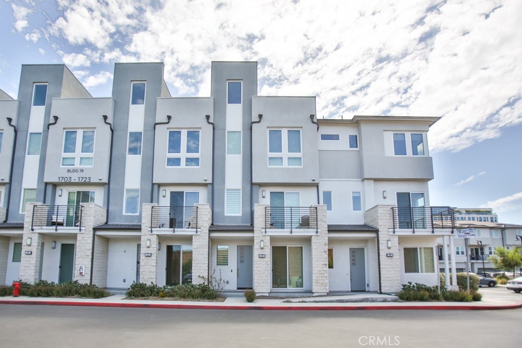 Nestled in the heart of Anaheim, this stunning 4-bedroom, 3.5-bathroom luxury condo offers the perfect blend of sophisticated design and resort-style living in the prestigious 100 West Gated Community by Toll Brothers. The thoughtfully designed layout begins on the ground level with a versatile bedroom and full bathroom, ideal for guests or a private home office, along with direct access to an upgraded two-car garage featuring epoxy flooring and an EV charger outlet. Ascend to the second floor to discover an expansive open concept living area adorned with rich dark brown vinyl flooring, plush carpeting, recessed LED lighting, and custom paint. The chef-inspired kitchen is a masterpiece, showcasing beautiful white Shaker cabinets, gleaming granite countertops with a full backsplash, premium Whirlpool stainless steel appliances, and a spacious center island perfect for casual dining. Two sets of sliding glass doors open to private balconies, offering tranquil neighborhood views. The third floor presents a luxurious primary suite complete with a generous walk-in closet and an ensuite bathroom featuring dual vanities with quartz countertops and a walk-in shower. Two additional sun-filled bedrooms, each with double-pane windows and custom blinds, provide comfort and privacy. The rooftop deck serves as an exceptional entertainment space with breathtaking views of Disneyland's nightly fireworks. Modern comforts include a Nest-controlled central AC system and a fully equipped solar power system for energy efficiency. Residents enjoy exclusive access to community amenities including a sparkling pool, two dog parks, BBQ areas, and beautifully landscaped courtyards. Perfectly positioned just minutes from Anaheim's finest attractions (The Packing House, Disneyland, Honda Center, Angel Stadium, and premier shopping), this move-in ready condo represents Southern California luxury living at its finest. Don't miss this rare opportunity to own an exceptional property in one of Anaheim's most desirable communities.