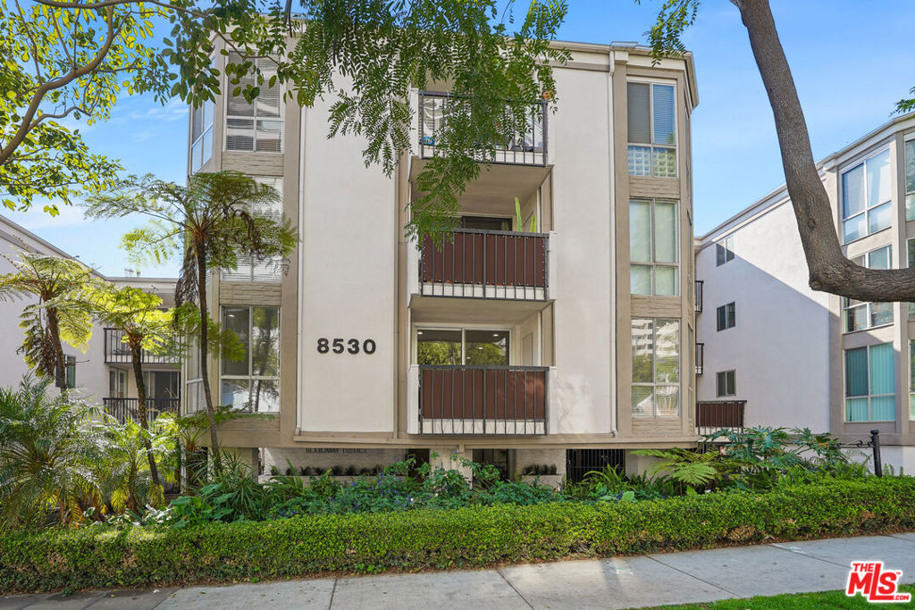 Step into a rare blend of modern elegance and California cool with this stunning 2-bedroom, 1.5-bath retreat nestled in the vibrant core of West Hollywood. Spanning 1,017 square feet of thoughtfully curated space, this designer-renovated residence is more than just a home, it's a lifestyle statement. From the moment you walk in, sleek bamboo floors and streaming natural light set a sophisticated tone. The open-concept living area centers around a chic, modern fireplace perfect for cozy evenings or upscale entertaining. Slide open the glass doors to your private balcony and enjoy your morning coffee or sunset cocktails in total serenity. The chef's kitchen is a showstopper. Outfitted with bespoke cabinetry, a striking combination of quartz and Caesar stone countertops, and top-tier stainless appliances, it's both a culinary workspace and a conversation piece. The oversized island with bar seating invites gatherings, while an adjoining dry bar complete with a built-in wine fridge adds a splash of luxe to any occasion. Retreat to your spacious primary suite, where comfort meets sophistication. A generous closet and spa-inspired bathroom with dual vanities and premium fixtures elevate your daily routine. A second bedroom offers flexibility for guests, a home office, or creative studio tailored to your lifestyle. This residence also comes with two side-by-side parking spaces and access to a host of resort-style amenities: unwind in the heated pool or jacuzzi, socialize in the clubhouse, break a sweat in the gym and sauna, or bask in panoramic city views from the rooftop sundeck. Tucked just moments from West Hollywood's most iconic hot spots Sunset Strip, Melrose Ave, Santa Monica Blvd this home places you in the epicenter of LA's most coveted neighborhood.