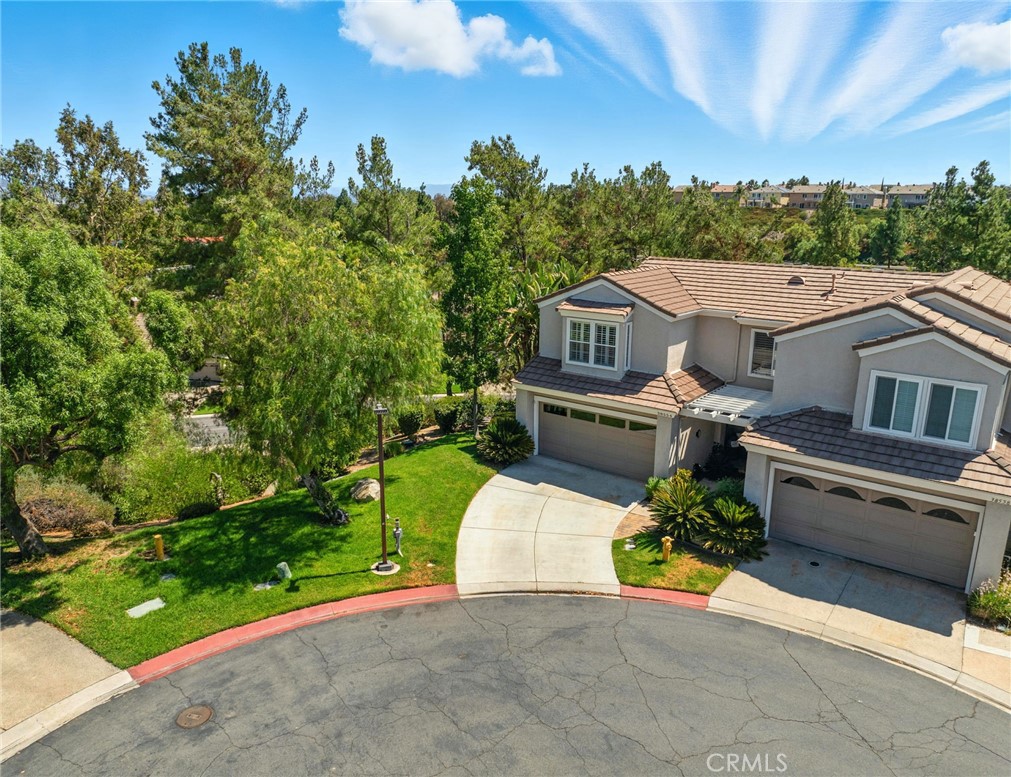 RARE Country Club Villas Location!! Superb end unit with NO REAR OR SIDE NEIGHBORS.... Complete Privacy! Immaculate and beautifully upgraded, Featuring LVP floors w/6inch base boards throughout, high ceilings, ample windows w/treetop views. The family room offers a dual sided fireplace w/custom tile surround and mantel, large dining area open to family room. The kitchen has new quartz counters, full subway tile backsplash, built-in stainless appliances, single basin black bottom sink, dual pantries (custom built to provide an abundance of storage) and coffered ceiling w/crown molding. Two oversize secondary bedrooms that share and upgraded hallway bath featuring: granite counters, custom backsplash, designer lighting, tub shower combo with seamless glass door and custom surround. The primary suite is serene w/high ceilings, cozy fireplace and treetop views. The primary en-suite is simply stunning offering a custom tile walk-in shower w/linear drain, seamless glass door, elegant hardware, freestanding soaking tub, dual vanities, quartz counters, vessel sinks, custom hardware and finished off with a walk-in closet with custom built-ins. Outdoor entertain in the wrap around patio with treetop views overlooking the community, large patio area, no neighbors. This unit features an extra-long driveway, outdoor storage space for your garbage cans, close to the community center (pool, spa, gym, sauna, pickleball, tennis, bocce ball and playground. The golf club offers social and golf memberships for dining and golfing packages. Bear Creek is an all-ages guard gated community close to dining, shopping and easy freeway access. Truly an exquisite property with so many designer touches.