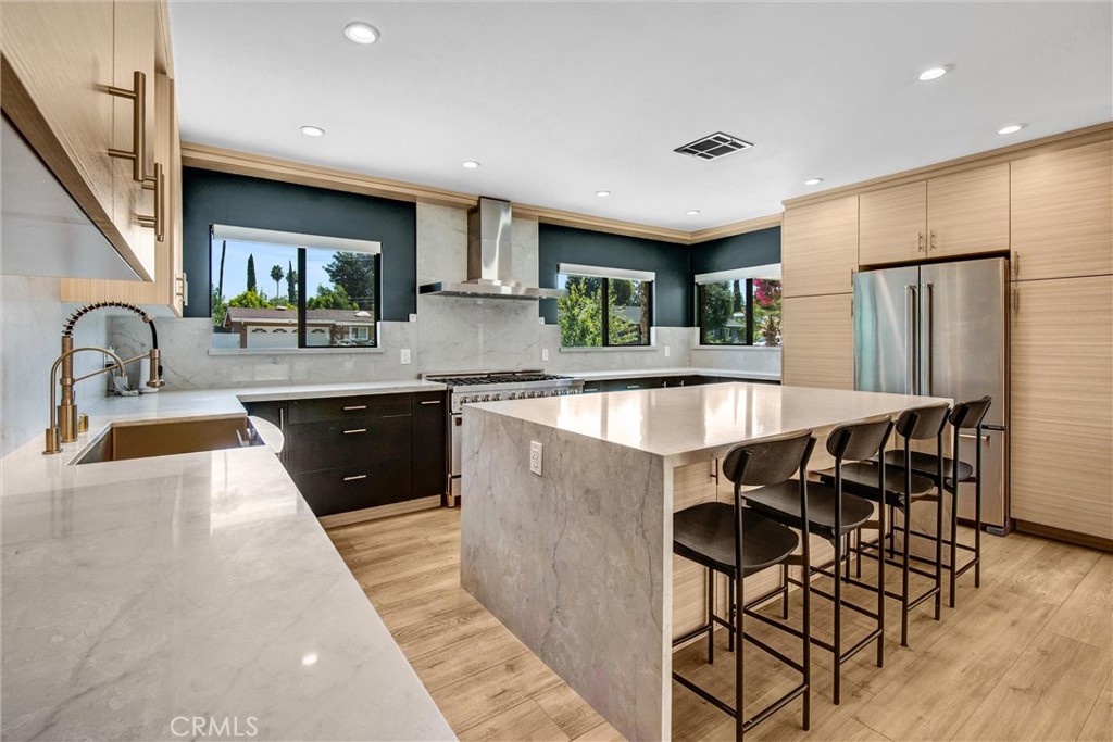 Welcome to this beautifully remodeled mid-century masterpiece located in the heart of prestigious Woodland Hills! Behind its timeless facade you’ll discover soaring beamed ceilings, an abundance of natural light, a large living/dining room area, and an elegantly upgraded kitchen! The luxurious primary suite is generously sized and features double closets along with a beautifully designed en-suite bath. Designer finishes seamlessly complement the home’s original mid-century details, creating a perfect harmony of classic and contemporary style. Expansive walls of glass open to a generous covered patio ideal for al fresco dining and relaxation, overlooking a private, resort-like backyard framed by mature landscaping and high walls. With ample grassy space, this outdoor retreat offers total seclusion and endless possibilities. Recent updates include a lifetime shingle roof, energy-efficient double-pane windows, and an updated HVAC system to ensure year-round comfort. This is a rare opportunity to lease a turnkey mid-century modern estate "South of the Boulevard" in Woodland Hills!
