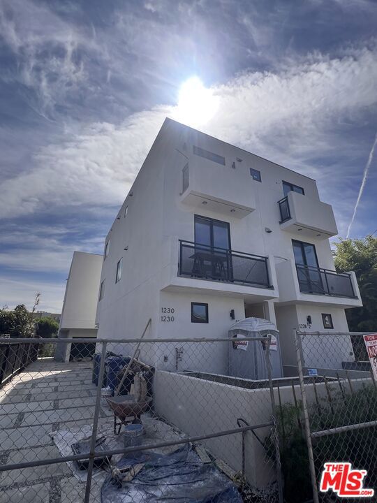 Move In Special: One Month Free! Welcome to 1228 S Berendo Street! Be the first to live in this newly constructed, stylish 3 bed + 2 bath townhouse-style unit, centrally located in the vibrant Mid-Wilshire neighborhood. Two beautifully designed units are available: 1228 and 1228 1/2. Step inside to find gorgeous hardwood floors throughout and a sun lit main level with a bright, open-concept layout. The modern kitchen comes fully equipped with stainless steel appliances, including a refrigerator, stove, and over-the-range microwave. Ample cabinetry and a sleek kitchen island offer plenty of prep and storage space perfect for entertaining or daily living. The kitchen seamlessly flows into the spacious dining and living area, which features a private balcony for relaxing or enjoying your morning coffee. A full bathroom and one bedroom are also conveniently located on the main floor. Upstairs, you'll find three additional bedrooms and two full bathrooms. Top it all off with a private rooftop deck, the perfect space for outdoor dining, relaxing, or taking in city views. The ground level features a private 2-car garage and a private fenced front yard. For added convenience, there are washer & dryer hookups and central AC & heating in each unit. Moments away are popular restaurants, trendy cafes, & markets. (Move in special: one month free rent is prorated over a 12-month lease, base rent is $4,100. More pictures will be uploaded soon)