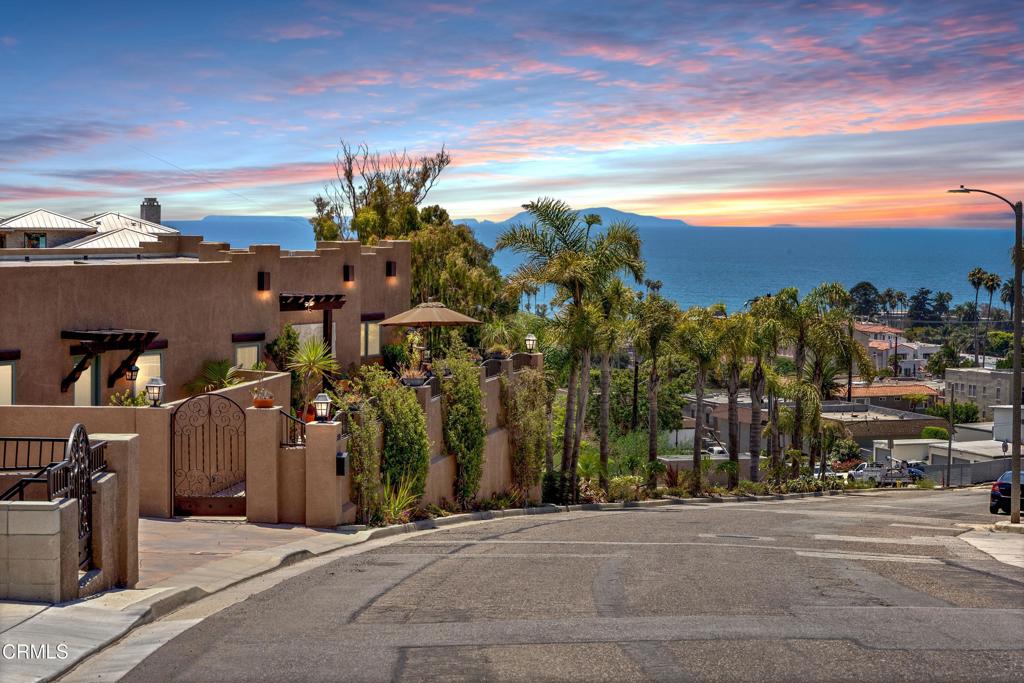 Just above downtown Ventura and the beach, this custom-built coastal home showcases panoramic ocean, island, and city-light views. With a coveted vacation rental permit, it's been enjoyed as both a second home and a successful short-term rental--offering flexibility, income potential, and the perfect turnkey getaway.The open-concept great room blends dining, kitchen, and living spaces, all opening to a view deck made for morning coffee or sunset cocktails. Quality craftsmanship is evident throughout--from the travertine-accented fireplace to Brazilian cherry hardwood floors, Pella windows and doors, custom alder cabinetry, and Viking appliances. A grand entry reveals soaring ceilings, a wrought-iron staircase, and natural light at every turn.On a generous 11,712 sq. ft. lot, this low-maintenance property is in impeccable condition and offers exciting potential to expand outdoor living space or develop the lower hillside level--maximizing the already breathtaking views.