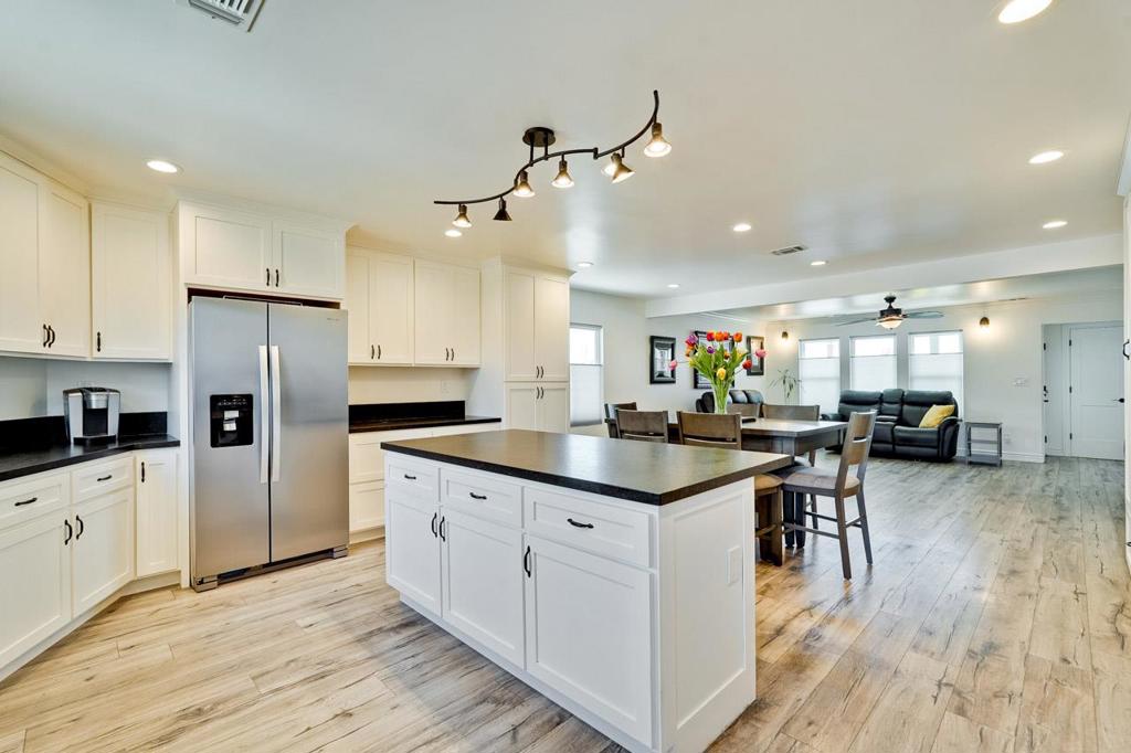 LOVINGLY maintained, with a significant permitted EXPANSION in 2019, this CHARMING 3 bedroom, 2 full bath, SINGLE story home features an AMAZING great room and comfortable living space. Gatherings of all sizes are possible. The THOUGHTFUL remodel includes a separate LAUNDRY room, sliding door from the primary suite to the deck, central heating and AIR-CONDITIONING, dual pane windows, REMODELED bathrooms with stall showers, TIMELESS finishes, and multiple WALK-IN CLOSETS. The kitchen features a GAS RANGE with EXHAUST HOOD (don't miss the pot-filler), grand ISLAND, a FANTASTIC amount of counter space & FABULOUS cabinet storage - including a PANTRY. Vinyl plank flooring flows throughout. LOW MAINTENANCE/water use landscaping both front & back increases enjoyment of your PRIVATE outdoor spaces. BBQ on the deck, plant some veggies in the raised bed & enjoy nature. Access is to the yard is through the kitchen making it CONVENIENT to take your gatherings OUTDOORS. EXTRA parking in the long driveway provides space for your TOYS. The single car garage has EXPANDED storage space. Think about what you could do with it. Clubhouse? Home office? ADU? So much potential! EASY commute location. Close to shopping, dining & entertainment. This home is MOVE-IN READY. You will LOVE it!