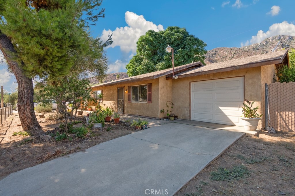 2 bed, 1 bath home sitting on a large 9,148 sqft corner lot is ready for its new owner. Offering a fully fenced front yard, with gated parking, beautiful mountain views, an attached 1-car garage, and driveway parking. The interior is open and spacious with laminate wood floors. The living room opens to the dining area which sits just off of the kitchen with wood cabinetry and included refrigerator and gas range. Both bedrooms are generously sized and there is a full-size hall bathroom. Enjoy the fully-fenced, private backyard with covered patio, and trees that add lots of shade, this space is ready for the new owner's design! No HOA and conveniently located near schools, shopping, dining, and the lake is located just a few blocks away! Schedule your tour now!