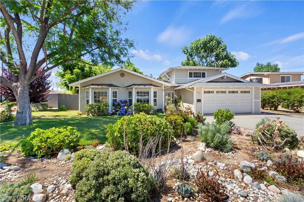 Large Home in the highly desirable City of La Verne and Bonita School District! This stunning 6-bedroom, 2-bathroom residence offers 2,325 square feet of comfortable living space on an 8,179 square foot lot. The unique floor plan began with the original 1964 design, similar to others in the neighborhood, but an extensive remodel in 2004-2005 (new living room and dining room in the front of the house) added approx. 600 square feet of living space and opened up the interior by removing walls and adding windows and additional lights. Upon entering you find yourself in the spacious formal entry and dining room with high ceilings. Just beyond is the spacious living room with vaulted ceiling. The kitchen upgrades in the remodel feature a new gas stove, wrap-around workspace/bar, faux stone laminate counters, and rustic tile backsplash, all generously lit by recessed and pendant fixtures. The elegant wood cabinets include a lazy susan and pull-out shelves in lower cabinets, a wall of floor-to-ceiling cabinets in the informal dining area, and a lighted built-in China cabinet. The kitchen further opens to the den/family room that features a gas fireplace.
The main bedroom has 2 closets and has direct access to the front living room and to the hallway. The main bathroom features a vanity area separate from the shower and toilet area. The secondary bathroom features a single sink, a tile tub/shower combination, and a low-flow toilet. There are four bedrooms on the lower floor. Upstairs the former large bonus room was converted into 2 bedrooms, each with its own separate air conditioner/heater wall unit. Downstairs you will enjoy the convenience of a new central air and heat pump system installed in 2023. Floors throughout are laminate stone tiles, interlocking laminate wood planks, and some carpet. A 2-car garage provides ample space for vehicles and includes a laundry area.
Outside, large shade trees help keep the yard and house cool. Landscaping is designed with some grass, some desert features, and pavers. There are views of the foothills/mountains to the north, and room for RV parking on the concrete driveway. With a perfect blend of space, comfort, and thoughtful amenities, and within walking distance to schools, downtown La Verne, restaurants, shopping, and more, this home is ready to welcome its next owners. Don’t miss out on this incredible opportunity!