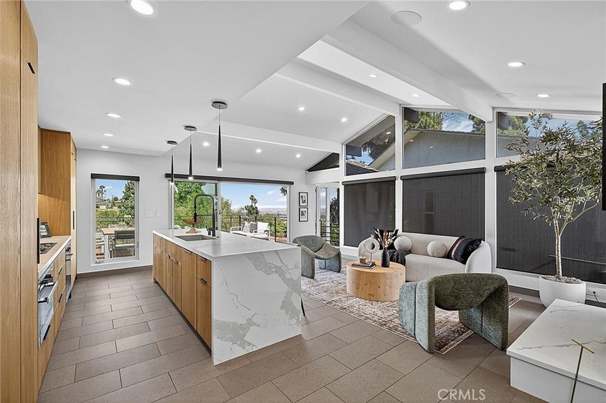 Presenting 6441 Via De Anzar  ~ Step into a world of comfort, class and sophistication with this stunning 3-bedroom 3-bath residence featuring excellent overall design, flow along with an unmatched living experience. This gorgeous Resort-Styled View home is Zen inspired and features a modern flare. Upon entering through the Kerf cut flush pivot entry door you'll be welcomed by a thoughtfully designed layout featuring a spacious living room that seamlessly connects to a modern kitchen outfitted with newer high-end Miele appliances, custom Blum soft close cabinetry, Thermador refrigerator/freezer along with a beautiful kitchen island. The Fleetwood sliding windows allow for a seamless transition between indoor and outdoor living. The open-air entertaining deck spaces are perfect for al fresco dining, morning coffee, or sunset cocktails. A stunning blend of style and function, this home features a designer-inspired open floor plan and premium finishes that elevate every space along with a warm family home feel. All three bedrooms are spacious and feature rear yard/deck access points. The resort-styled primary retreat features a massive walk-in closet, a spa-inspired walk-in En-Suite bath, dual sinks, Kohler Numi smart toilet, large soaking tub, Kallista custom black matte fixtures and a Seura mirror TV. The home is adorned beautifully & adjusts to any lifestyle from the family/kids study-play area, to the sophisticated adult entertaining space. Take notice of the massive storage cabinet space on the lower level along with a dedicated tech room and a separate fire rated safe/storage room. Additional features include professionally installed and fully integrated smart home iPads controlling much of the home along with the Sonos indoor/outdoor speakers, brush nickel aluminum windows with custom rollup blackout shades, air conditioning and a mini split in the garage, automated smart water monitor shut-off, Wi-Fi leak detector, Lutron smart Wi-Fi switches, my Q smart garage door opener, Nest protect smart smoke, CO2 detectors / thermostats and a Honeywell ADT alarm system. The Home Commands Attention at every corner. Come take a look at this Stunning Residence !!!