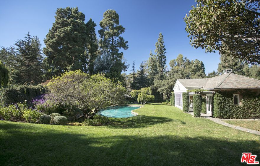 Situated in prominent Holmby Hills, this picturesque estate boasts 2.2 acres of verdant sprawling grounds with grand, mature trees, idyllic gardens, a koi pond, cobblestone pathways, peaceful fountains, a championship tennis court and a funicular. The structures on the land consist of a 2 bedroom, 3 bathroom guest house, as well as a separate two story pool house that opens to the swimming pool and outdoor lounge areas. The guest houses offer unparalleled craftsmanship that seamlessly creates a deep connection of indoor-outdoor living. The perfect opportunity to build a grand main house to complete this spectacular compound. This is a unique opportunity in one of Los Angeles's most sought after locations for a discerning individual looking to transform their dream compound into fruition.