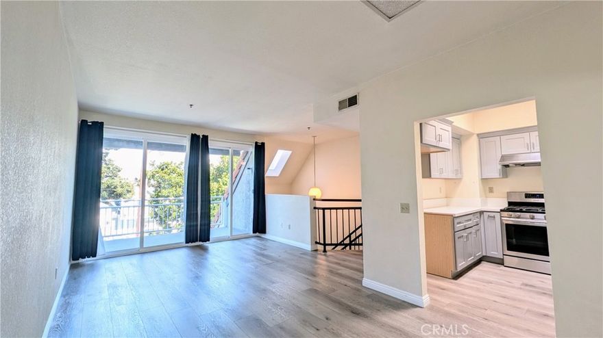 This beautifully maintained 3 bedroom, 2 bath two-story home sits on a peaceful tree-lined street. With approximately 1,500 square feet of living space, the layout is open and filled with natural light from newer dual pane windows. The spacious downstairs primary suite includes a generous walk-in closet and a stylishly upgraded bathroom featuring a tile walk-in shower. Two additional bedrooms are located down the hall, along with under-stair storage, a laundry closet with washer and dryer hookups, and a second upgraded bathroom with quartz countertops and a shower/tub combo. Upstairs, enjoy a bright and airy living and dining area that opens up to a large balcony with treetop views. The updated kitchen features quartz countertops, shaker cabinets, a stainless steel sink, a high-performance Maytag dishwasher, and a Samsung oven and stove. A separate oversized den offers flexible space for work or play. Additional highlights include central heat and air conditioning plus secure gated access to a dedicated 2-car garage with built-in storage cabinets. Located just blocks from downtown Alhambra, Almansor Park, schools, and minutes from Downtown Los Angeles, this home combines comfort and accessibility in a sought-after neighborhood.
