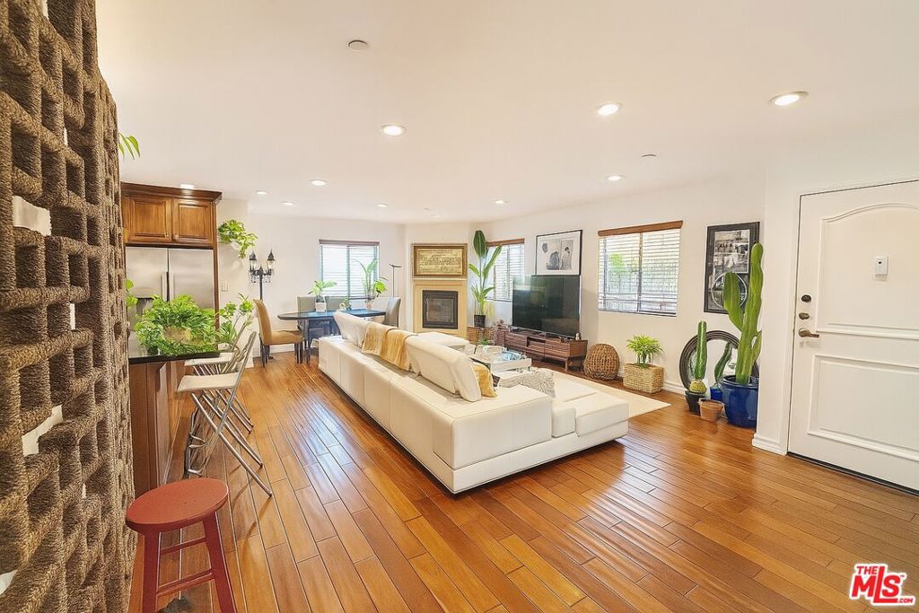 Welcome to an elegant and expansive 3 bedroom, 2 bathroom top floor residence in the heart of West Hollywood offering nearly 2,000 square feet of refined living space. Perfectly situated on the third floor of a well-maintained building near La Cienega and Santa Monica Boulevard, this front-facing unit combines the spacious feel of a private home with the convenience of luxury condo living.Step inside to a bright and open floor plan featuring rich hardwood floors, recessed lighting, and abundant natural light throughout. The generous living and dining area opens to a private balcony creating the ideal setting for entertaining or unwinding. The kitchen is a chef's dream complete with a large center island, granite countertops, and stainless steel appliances including a gas stove, refrigerator, dishwasher, and built-in microwave. The oversized primary suite includes a spacious en suite bathroom with double sinks and ample closet space, while two additional bedrooms offer flexibility for guests, a home office, or family living. A full-sized washer and dryer in unit adds to the convenience. This residence also includes a private balcony and access to a beautifully maintained communal rooftop deck with stunning views. A community jacuzzi on the main level offers a tranquil space to relax and recharge.Additional features include two secured parking spaces in a gated garage and controlled access to the building.Enjoy unbeatable walkability with West Hollywood's most iconic spots just steps away. Barneys Beanery, Soho House Holloway, and countless cafes, restaurants, and nightlife destinations are all within a short stroll.This unit is offered unfurnished.