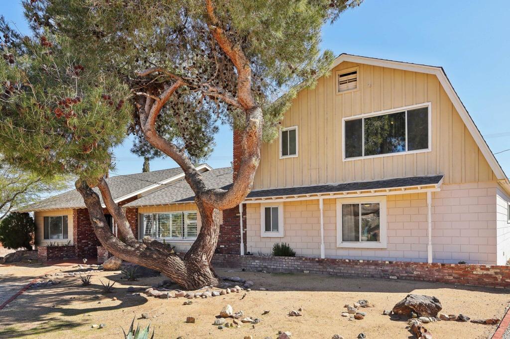 Stylish Modern Retreat on Half Acre Lot with Pool in Yucca Valley! Welcome to this incredible modernized home in Yucca Valley, set ona sprawling 1/2 acre lot with exceptional curb appeal. The hardscaped front yard with drought-tolerant plants ensures easy maintenance while adding a touchof desert elegance. Go inside to find tile flooring, beamed ceilings, and wood shutters that beautifully complement the fireplace with a raised hearth andmantle in the cozy living room. The open floorplan seamlessly connects the living, dining, and kitchen areas, making it perfect for entertaining. The bright,luxurious kitchen boasts white cabinetry, full quartz slab backsplash, stainless steel appliances, and quartz countertops with peninsula seating. Enjoystunning pool and mountain views from the kitchen window, and step through the glass door leading to the breathtaking backyard. Your fully fenced backyardoasis features a sparkling pool, an expansive covered patio perfect for dining, lounging, and cooking, and an additional paver patio at the far corner, ideal forsoaking up the sun. There's also gated RV parking at the side of the home. The huge primary suite is privately situated on its own side of the house, offeringdouble French doors, a fireplace, a spacious cedar walk-in closet, and a modern en suite bathroom. Down the main hallway, two Jack and Jill-style bedroomsshare a spacious bathroom with a tiled shower and updated vanity. One of the bedrooms even includes a sauna for ultimate relaxation. An added bonus isthe game room or pool house, accessible both from the backyard and within the house--perfect for entertaining or as a guest suite. Conveniently locatednear 29 Palms Hwy, this home offers easy access to local markets, shopping, and dining options. Experience the best of desert living in this stunning YuccaValley retreat! Don't miss out--schedule your tour today!