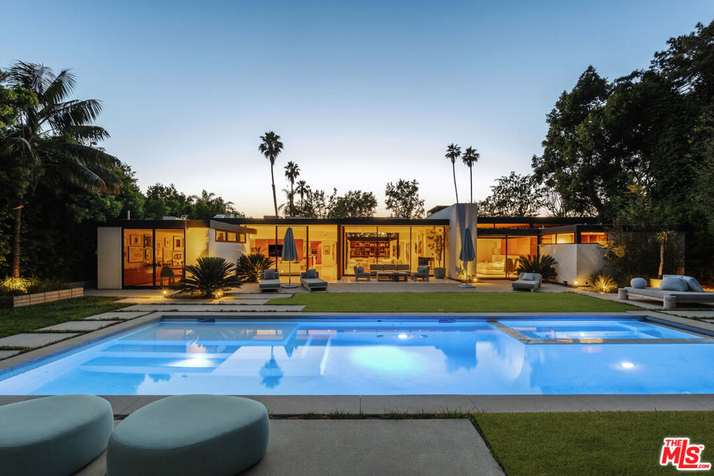 Timeless and elegant restoration by Woods and Dangaran of a classic Trousdale Mid-Century by influential architect Rex Lottery. Five bedrooms, Six bathrooms in approximately 6000 sf on one level with gorgeous, understated finishes , high ceilings and stunning light. The house is gated, private and set back from the street on a beautifully landscaped 20,000 sf lot with large motor court, pool, spa, grassy yard and sylvan grounds. Shown by appointment.