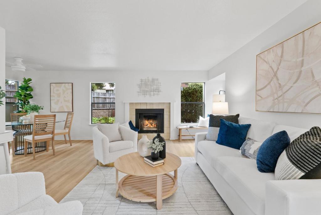 Tucked away in a quiet corner, this Hidden Oaks home has been lovingly cared for by the same proud owner for many years. Located only steps from The Kings Village Shopping Center, offering coffee shops, groceries, good eats, and movies at the CineLux. The detached garage (#16) is conveniently located nearby, not through a maze of pathways like some other units, and features a workspace perfect for tinkering and repairing toasters and small electronics. This ground floor, single level unit boasts windows on all four sides, a fireplace, indoor laundry and generous closet and storage space. The home features two bedrooms, two full bathrooms, and has been updated with new designer-selected flooring, paint, modern light fixtures, and hardware. Whether you're a first-time homebuyer, commuter, downsizing, or retiring, this unit checks all the boxes. And the timing is perfect for you to move in just in time to enjoy warm fall days at one of the two community pools or two hot tubs.