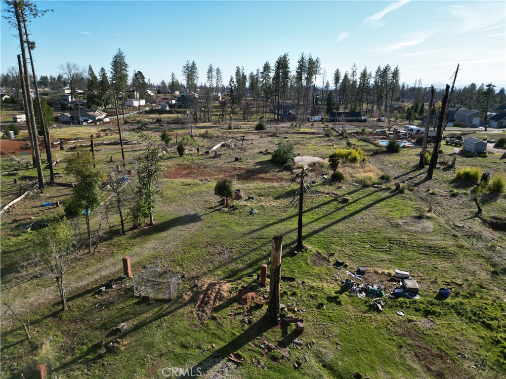 Excellent opportunity for builders! This flatter flag-shaped 1-acre lot, located just steps from Bille Park, is ready for your next project. PRICED TO SELL!! Previously home to a 2,300 sq ft, 3-bedroom, 3-bathroom residence, the site offers a generous footprint with utilities nearby and an existing septic system (condition unknown). The peaceful yet accessible location is ideal for future buyers looking to enjoy nature while staying close to town amenities. A great canvas in a desirable Paradise location, bring your plans and start building. Buyer to verify all information to their satisfaction.