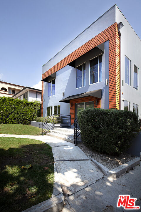Beautifully Remodeled 3-Bedroom, 3-Bath Modern Townhome. This stunningly remodeled townhome features 3 spacious bedrooms and 3 full bathrooms, offering the perfect blend of comfort, privacy, and style. The home showcases a sleek modern design with hardwood floors throughout, a fully upgraded kitchen with state-of-the-art appliances, and the convenience of your own in-unit washer and dryer.Tucked away at the rear of the building, this residence feels private and secluded, making it ideal for both everyday living and entertaining. All three bedrooms are located upstairs, with beautifully updated bathrooms providing both function and luxury.The building includes a fantastic rooftop deck, complete with two separate lounge areas. Whether you're entertaining friends or unwinding in a chaise lounge, you'll enjoy spectacular views including a direct sightline to the Hollywood Sign.Located in one of the most desirable neighborhoods, you'll be just steps from Franklin Avenue's popular dining spots like Birds, Gelson's Market, and countless other local favorites.Additional highlights:Two side-by-side parking spaces behind the building Gated property with automatic gate opener. This home combines modern elegance with unbeatable convenience a must-see!