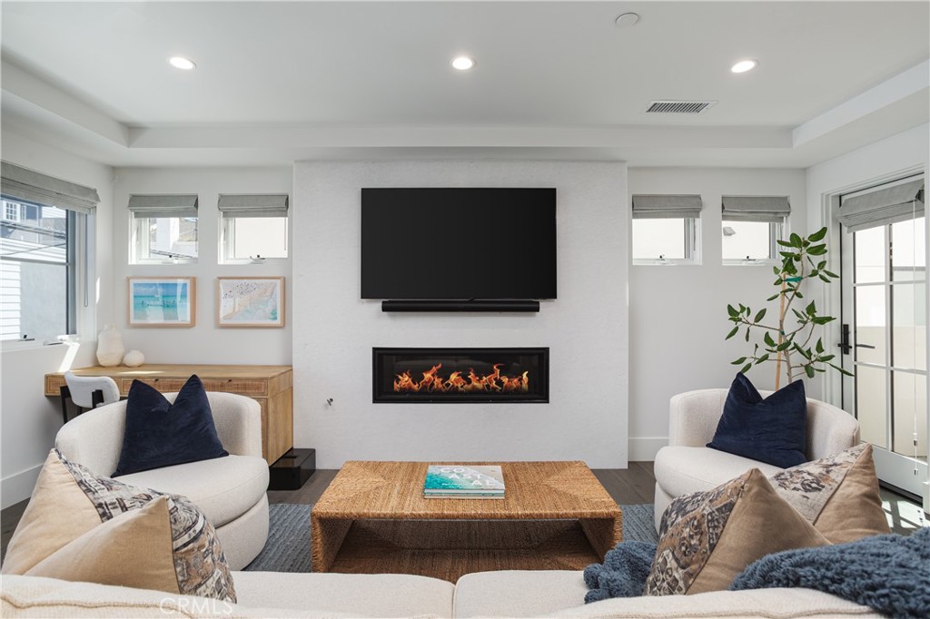 Set on a quiet street in the heart of Corona del Mar’s Village, 714 ½ Iris is a detached, stand alone back unit that combines quality, natural light, and thoughtful design. Completed in 2021 by Sonil Construction, the home offers a refined coastal aesthetic with clean lines, premium finishes, and effortless indoor-outdoor flow.
The main level features an open floor plan filled with light, anchored by real hardwood flooring and a neutral palette that enhances the sense of space and calm. The kitchen is finished with quartzite countertops, stainless steel Thermador appliances, and custom cabinetry—designed for everyday living with a streamlined, elevated lifestyle.
Upstairs, the primary suite offers vaulted ceilings, a walk-in closet, and a spa-like bath with a Victoria + Albert soaking tub, walk-in shower, and dual sinks. A secondary bedroom and full bath are situated on the main level, maintaining complete privacy.
A private rooftop deck expands the living space, offering a place to unwind by the fireplace and enjoy the soothing sunset—or relax in the jacuzzi beneath open skies. The home is also prewired for a professional-grade sound and security system and secured with exterior gates equipped with keypad access, blending convenience with peace of mind.
With no shared walls, private garage access, and a walkable location near beaches, shops, and restaurants, this residence offers a sophisticated take on Village living—low-maintenance, well-appointed, and effortlessly connected to the best of coastal Orange County.