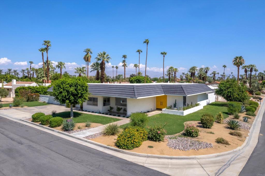 Welcome to Casa Via Corona, a 1970’s time capsule; family rental in coveted Indian Wells. Enjoy a stay at this mid-century desert home! With 2,203 square feet and three bedrooms, up to 8 guests can visit and experience all that Indian Wells has to offer. Recently renovated, this beautiful home is the perfect location for all your Indian Wells adventures. Light and bright, comfortable and warm, you’ll love this space. Situated on a corner lot with mountain views, you are just a short golf cart ride from El Dorado Country Club, a few minutes to El Paseo for some shopping and fine dining, and just a few blocks from the famous tennis tournaments. Enter through double doors to a foyer overlooking an atrium and leading to a spacious formal living area with vaulted ceilings and abundance of natural light. To the left you’ll find a formal dining room and beyond that waits a well laid out kitchen full of charm with sunny yellow accents highlighting the island, bar, sink and countertops. A charming pass through to the dining area throws us back to a time that dinners were a formal affair. On the other side of the formal living room is an office that doubles as a bedroom. A large guest room overlooks the atrium off the entry and a full bath is at the end of the hall, boasting its own outdoor access. The master bedroom is oversized and overlooks the pool, featuring an en-suite bath and dressing area with plenty of closet space, dual vanities and a groovy step-down tub overlooking its own private outdoor space. The yard is large and private. With no HOA and a three-car attached garage, this home has so much to offer. Minimum Stay: 29 nights (per City requirements). Call for more info!