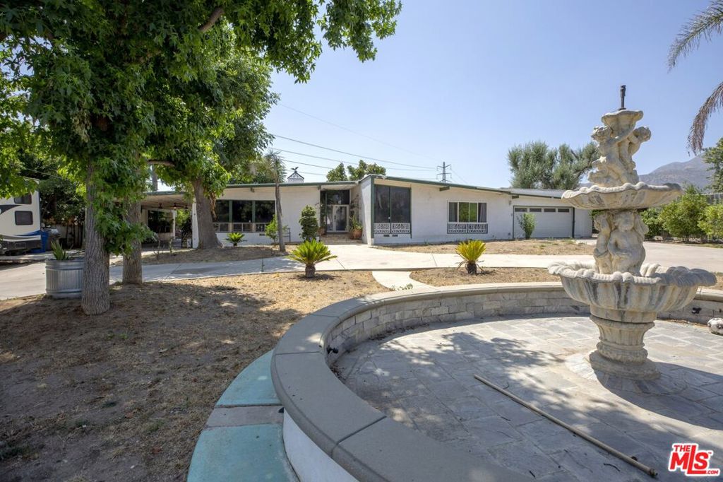 High demand ONE LEVEL 4 bedrooms 3 baths home on over 28.000 sf FLAT cul-de-sac-like lot. Horse zoned property has been a home for horses and other farm animals. The vacant area to the right of the house is INCLUDED! It has been used to park larger trucks but might be subdivided offering and incredible opportunity for a separate property with street frontage. This Texas-Sized Ranch conveniently located walking distance to charter and specialty (STEM and biotech) schools and minutes from 97 acres Veteran's Memorial Park with fun family gatherings in foothills and 18-hole golf course. Open floor plan with living room, dining room, double fireplace, an entertainment/great room that would fit a great piano, bright kitchen w/stainless steel appliances, laundry area, office and a gym. There is a grand circular driveway w/two electric gates and a water fountain, easy RV/trailer access and a 2 car garage. The house was recently re-plumbed and rewired.
