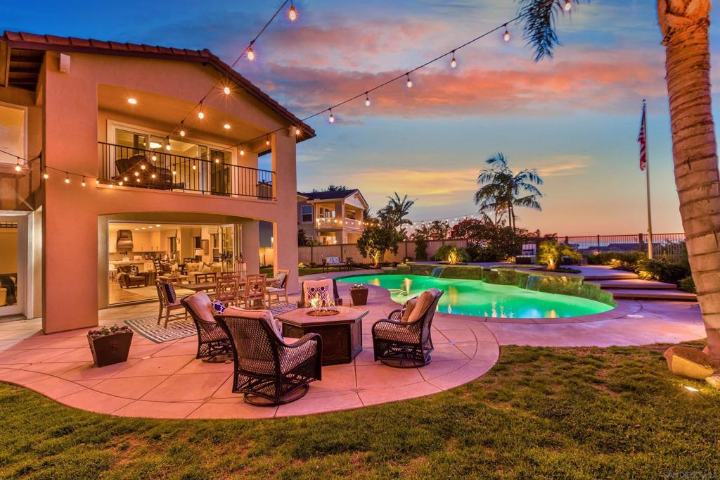 Perched high above it all in the exclusive gated community of Sandalwood, this coastal Encinitas home lives like a private resort. With sweeping ocean views, lush gardens, and a sparkling pool and spa, every day here feels like a vacation. Located on a quiet cul-de-sac with a 3-car garage and large driveway, this solar-powered home is as functional as it is beautiful. The oversized lot, more than 15,000 square feet, offers room to relax, entertain, and play. Enjoy vibrant rose gardens, mature fruit trees, manicured landscaping, and a covered loggia perfect for al fresco dining. Inside, the open-concept living area is designed for seamless indoor-outdoor living. La Cantina doors in the family room open wide to bring in ocean breezes and connect to the expansive yard. The remodeled chef’s kitchen features custom finishes and flows beautifully for hosting or everyday comfort. The thoughtful floor plan includes a first-floor guest bedroom and a generous bonus room upstairs. The spacious primary suite offers a private balcony with panoramic ocean views, perfect for morning coffee or evening sunsets. Three additional bedrooms, a large front balcony, newly remodeled bathrooms, and new upstairs flooring round out the upper level. Additional upgrades include custom window coverings, a newer furnace and air conditioning, pool equipment and energy-efficient systems throughout. Close to top-rated schools, shopping, dining, and iconic North County beaches, this is a rare opportunity to own an oceanview home in Encinitas. Come experience it for yourself.
