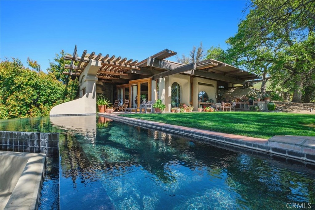 An unparalleled +/-700-acre property offering a rare combination of stunning natural beauty, multiple residences, and versatile amenities. This remarkable estate comprises three parcels approximately 545 acres, 80 acres, and 75 acres with breathtaking views and diverse terrain.
The primary residence, designed by renowned architect Gene Zellmer, spans approx. 4,100 square feet and showcases stunning views, an infinity pool, and majestic native oak trees surrounding the home. The second home is a spacious +/-1,888-square-foot, 4-bedroom, 2-bathroom residence with a 2-car garage, nestled among oak trees and surrounded by picturesque grazing land. The third home is a charming +/-710-square-foot cottage, complete with a kitchen, bathroom, 2 bedrooms, and living room. Nearby, you'll find a second swimming pool and an approx. 2,420-square-foot barn equipped with its own bathroom, as well as a chicken coop, horse/cattle pens, and a garden.
The property offers captivating views of Millerton Lake from various hilltops and features Cottonwood Creek meandering through its expansive acreage, adding to the tranquil, picturesque setting.
This one-of-a-kind estate is an exceptional opportunity for those seeking privacy, natural beauty, and the ultimate rural lifestyle.