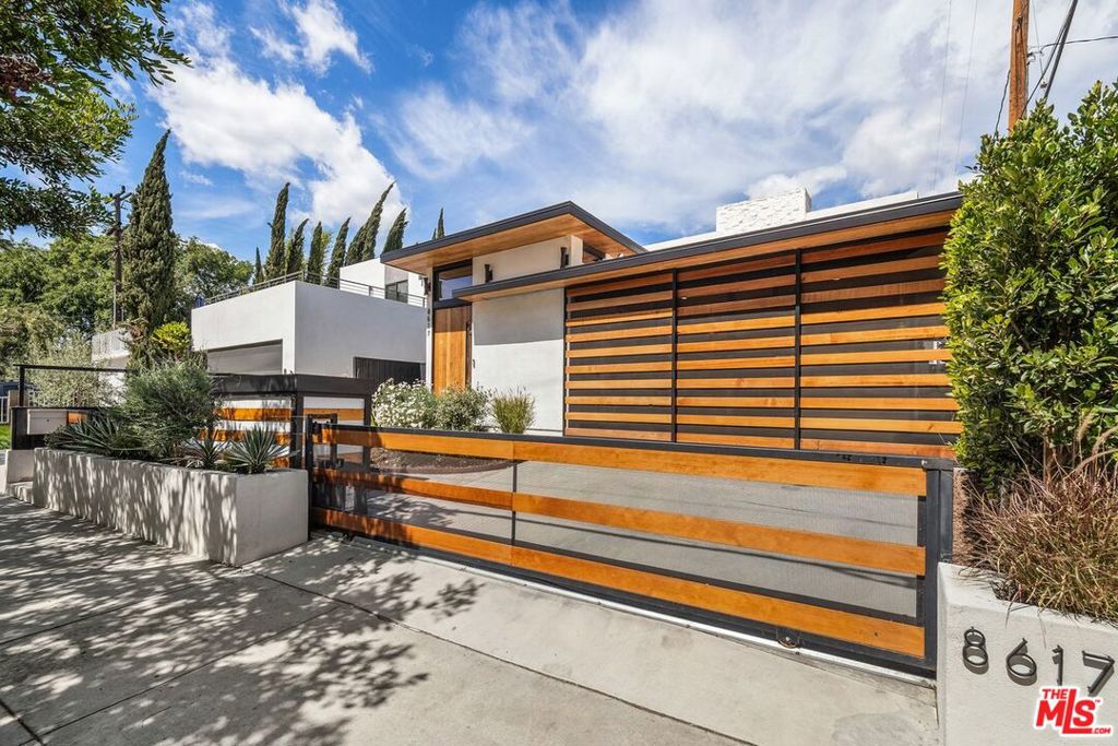 Unfurnished, Newer 2021 build, stunning architectural 5-bed/5-bath (Plus large office/6th bedroom) home exudes warmth, privacy and fine details in the highly sought-after Culver City "Lucerne-Higuera" neighborhood. Striking details provide the quality design elements behind this beautiful home starting with the custom gated, private, cedar covered parking for 4 cars with direct access. Grand 9-foot solid cedar with glass entry door transitions into a modern showcase foyer. Jaw-dropping "Great Room" has 15-foot ceilings, massive walls of glass windows, disappearing Fleetwood sliding doors take you from indoor to outdoor living seamlessly, custom floor-to ceiling fireplace with live edge monkeypod hearth, exceptional center-island kitchen with 48-inch Blue Star range, built-in Thermador refrigeration and walnut cabinets. Side yard has a custom built-in outdoor kitchen. Fully equipped media room/family room with another fireplace. 5th Bedroom is a convertible den. Wide plank oak floors and spacious "art walls" throughout. Wet bar with wine storage, fridge, and ice maker. Numerous built-in cabinets/shelves provide extra storage. Dolby 5.1 surround sound/Denon HEOS smartphone-controlled music throughout. Custom timed exterior lighting. Many exterior storage sheds. Dual tankless water heaters. Private Oasis-like, huge primary suite with high ceilings, fireplace, additional nursery/baby's room attached (6th Bedroom) and large spa style roof deck. Phenomenal walkability to highly rated Culver City schools and the eclectic "hip" vibe of downtown Culver City with the numerous shopping, theater/entertainment and dining opportunities including the Main Street Farmers Market and several Michelin rated restaurants. A short distance the other direction from the home takes you over the "Ballona Creek bike path to the beach" to the Baldwin Hills Scenic Overlook, the Stoneview Nature Center and the Kenneth Hahn state park. Close proximity to all major studios, the DTCC Metro train station, multiple freeways and LAX.