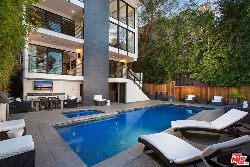 Experience luxury living in this ultra-modern estate spanning 4,600 sq. ft. of high-end design. This stunning home offers 5 spacious ensuite bedrooms and 5 bathrooms, all within an open-concept layout featuring sleek hardwood floors. The upscale chef's kitchen is a culinary dream, boasting an oversized island, Viking appliances, and a large wine cellar. Relax by one of the three wood-burning fireplaces or unwind in the master suite with a double steam shower, soaking tub, and spa-inspired amenities. Expansive windows provide breathtaking valley views, while the saltwater pool, spa, and private sports court create an outdoor paradise. The property is equipped with a smart home system for convenient control via phone or tablet, built-in speakers in every room, and a two-car garage. Nestled in a gated pedestrian-friendly area, this home offers endless upgrades and a lifestyle of comfort and sophistication.