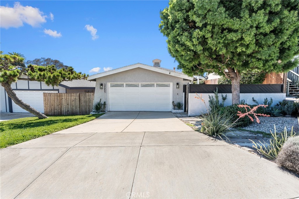 Welcome to your charming coastal cottage in the heart of Capistrano Beach! This single-story retreat offers 3 bedrooms, 2 bathrooms, and a relaxed seaside vibe you’ll fall in love with. Nestled on a 5,400 sq ft lot, the home greets you with a private front courtyard and a fenced backyard—perfect spots for lazy afternoons, morning coffee, or sunset gatherings. Inside, sunlight fills the open spaces, highlighting warm wood laminate floors that flow throughout. The kitchen, with its newer cabinetry and airy layout, connects seamlessly to the family room, making it easy to entertain or simply enjoy time together. Cozy up by the fireplace, surrounded by built-in cabinets and designer shelving, or slide open the doors to let the ocean breeze drift in.
The primary suite feels like its own private hideaway, complete with a sliding door to the deck and an en suite bathroom for added comfort. A spacious garage offers built-in storage and laundry hook-ups, keeping things practical while still laid-back. Ideally located just minutes from Dana Point Harbor, San Clemente’s beaches, and the charm of historic San Juan Capistrano, you’ll have endless coastal adventures, local dining, and boutique shopping right at your doorstep.