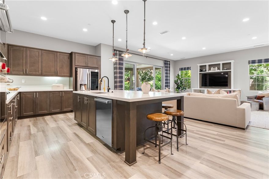 Welcome to your dream home in Esencia! This impeccably designed Plan 3 residence is in the highly desirable Brioso enclave in the award-winning community of Rancho Mission Viejo. Offering 4 bedrooms, 4.5 bathrooms, and a flexible loft space, the home is thoughtfully crafted to suit a variety of lifestyles whether you're entertaining, relaxing, or expanding. The primary suite is located on the main floor and serves as a luxurious retreat, featuring a spacious walk-in closet and a spa-inspired bathroom with a soaking tub and walk-in shower. As you step into the expansive great room, you're immediately struck by the natural light and seamless flow. The gourmet kitchen takes center stage with its oversized island, upgraded Wolf appliances, and sleek finishes, while a sparkling and filtered water system at the sink adds a touch of everyday luxury. The wide sliding glass doors open effortlessly to a private backyard retreat, perfect for hosting unforgettable gatherings or enjoying peaceful evenings outdoors. The upstairs loft offers flexibility and can easily be transformed into a fifth bedroom, home office, or media room to suit your evolving needs. Another en-suite bedroom is located downstairs, ideal for guests or multi-generational living. The home also features an owned solar system with a car charger, custom built-in cabinetry in the garage with epoxy flooring, and a backyard designed for entertaining complete with a bocce ball court, a custom Tiki Bar with built-in BBQ and fridge, and plenty of space for hosting. Every inch of this home reflects thoughtful design, upscale finishes, and a lifestyle that embraces both comfort and sophistication. This is more than just a home, it’s your opportunity to live beautifully in Rancho Mission Viejo. Immerse yourself in the exceptional amenities of Rancho Mission Viejo, including the vibrant Ranch Camp, the state-of-the-art Ranch Cove community pool and gym, and countless recreational opportunities that define the unmatched lifestyle of this community. Exclusive to Rancho Mission Viejo residents are all amenities in the Villages of Sendero, Esencia, Rienda, and future Villages. There are community amenities for all from breath-taking resort-style pools and spas, Esencia school K-8, community farms, fitness centers, guest house, putting green, bocce ball courts, tennis and pickle ball courts, playgrounds, coffee shop, fire pits, an arcade and so much more!