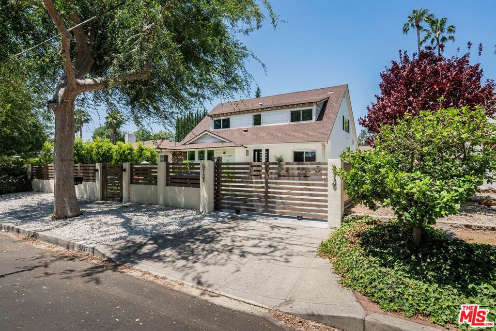 Welcome to 5737 Allott Avenue, a stunningly renovated property located in a quiet, highly sought-after pocket of Van Nuys in the tree lined street of Valley Glen. This unique offering includes a beautifully upgraded 4-bedroom, 3.5-bathroom main house spanning approximately 2,407 sq ft, plus a fully permitted, spacious 2-bedroom, 2-bathroom ADU with its own kitchen and laundry, adding an additional 903 sq ft of living space. Ideal for families, entertaining, or hosting guests, this property offers both flexibility and function in a warm, community-oriented neighborhood where neighbors are friendly and residents enjoy peaceful walks throughout the day. The main house was thoughtfully renovated and features luxury vinyl plank flooring throughout, dual-zone HVAC systems controlled by Nest thermostats, and energy-efficient solar panels (leased). The first floor boasts an expansive, open-concept layout with a large double living room, perfect for gatherings and entertaining. The chef's kitchen is the centerpiece of the space, featuring an 8-foot island, built-in pantry cabinets, a beverage fridge with dual-temperature zones, Bosch counter-depth refrigerator (included if desired), and premium fixtures including a filtered drinking water and hot water dispenser. A guest bedroom with an en-suite bathroom is located on the first floor, along with a stylish powder room and ample storage under the stairs. Upstairs, the spacious primary suite offers a walk-in closet and a spa-inspired bathroom complete with a floating double vanity, large soaking tub, and separate shower. Two additional bedrooms, including one oversized room with double closets, share a full hallway bathroom. The upstairs laundry area is conveniently located at the top of the stairs, making daily chores a breeze. Outside, the property is fully fenced with a private driveway that easily accommodates two vehicles. The wood-toned composite fencing and brand-new motorized gate (2025) ensure both privacy and curb appeal. The front yard features a lush turf lawn lined with mature ficus trees, creating a peaceful and private setting. In the backyard, you'll find a low-maintenance outdoor oasis complete with a medium-sized saltwater pool and built-in hot tub, controlled via smartphone, and surrounded by tasteful concrete and stone accents. A composite deck with dual sliding patio doors, large pergola with adjustable louvres, and optional outdoor heater make this the perfect setting for year-round enjoyment. A safety glass pool fence can remain or be removed at the buyer's request. The recently completed ADU is a modern and well-appointed space ideal for guests, extended family, or rental income. It includes a full kitchen with new appliances and a peninsula counter, a comfortable living room that opens to the pool area through large sliding doors, in-unit laundry, and two full bathrooms. The main bedroom includes an en-suite bath with a large shower and vanity, while the second bath accessible from the exterior makes it easy for poolside use. 5737 Allott Ave is more than a home, it's a lifestyle upgrade. With tasteful, turnkey renovations, smart technology, and versatile living spaces, this property is perfect for anyone looking for low-maintenance luxury in one of the Valley's most welcoming neighborhoods.