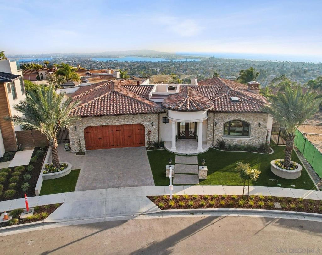 Views, views, views - This stunning Mediterranean villa, completed in December 2024, sits on the La Jolla–Pacific Beach border, offering sweeping ocean and city views from the Coronado Islands by day to twinkling city lights by night. Spanning 4,927 sq. ft., this 4-bd, 3.5-bath estate features an open-concept layout with polished marble floors, open-beam ceilings, and a dramatic Italian stone fireplace. The chef’s kitchen boasts a large granite island, custom service cart, and premium built-in appliances. The first-floor master suite is a private retreat with hardwood floors, a soaking tub, dual vanities, a spa-like ensuite, and a designer walk-in closet with integrated laundry. Enjoy seamless indoor-outdoor living on the first floor's 420 sq. ft. covered patio, featuring a built-in Wolf gas BBQ, icemaker, TV, overhead heaters, and strategically placed wind-blocking glass panels. A 413 sq. ft. rooftop offers unmatched views with a gas fire pit. The lower level, accessible via stairs or elevator, includes a great room, a second fully equipped kitchen, wine cellar, fireplace, and 3 bdms/2 baths, including a second master suite with a steam/shower room, walk-in closet, and private laundry. The lower level has a 739 sq. ft. covered patio with a firepit that overlooks the pool and spa, all set against breathtaking views of the Pacific. The entire house is wired with a Sevant Whole Home audio, built-in vacuum system, solar system, remote skylight, etc., ... no expense spared. This home defines luxury coastal living—a rare gem in one of San Diego’s most desirable locations.