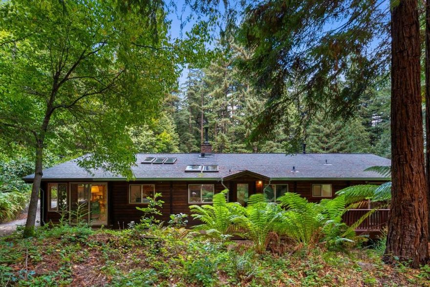 Escape the hustle and bustle of the busy Bay Area in this country retreat. Located only minutes from Highway 9 and Ben Lomond shopping, this 1,458 square foot, three bedroom, one bathroom log home exudes charm. Built-in knotty pine bookshelves create a library-like setting in the family room. A fireplace in the living room as well as forced air will keep you cozy on winter nights. Multiple skylights throughout the home create an abundance of natural light, and there are views of greenery from every window. There is a huge pantry in the separate laundry room so that you can stock up. A wide front porch overlooks a fully fenced and sun-drenched expansive flatter lawn area, perfect for creating a vegetable garden. Several venerable apple trees provide both ambiance and edible fruit. Carport and several sheds for extra storage. Situated on 30+ private acres, with a spring for water and a passing septic system, this home would be a wonderful year-round dwelling and provide a private escape during the hot summer months. This retreat is the place to create wonderful memories!