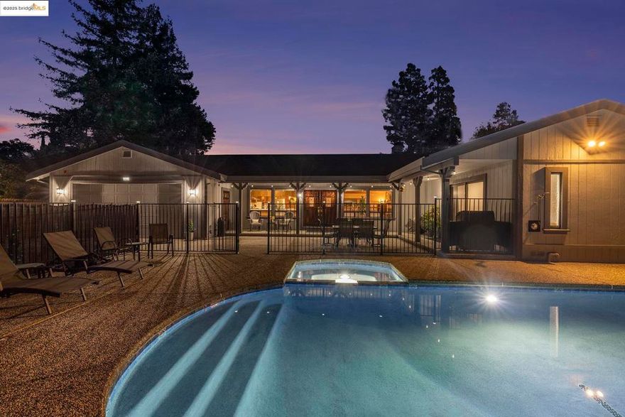 Tucked away at the end of a private lane shared by just six homes in Concord’s Mt. Diablo School District, this custom single-story home offers 2,705 sq. ft. on an 11,250 sq. ft. lot. A rare front-yard recently refinished PebbleTec pool and spa greet you with a stunning water element. Inside, vaulted tongue-and-groove wooden ceilings, exposed beams, and a wood-burning fireplace insert plumbed for gas complement the open-concept kitchen, great room, and living room. The chef’s kitchen features a prep island, stainless steel KitchenAid appliances, 60" hood, 36" cooktop with 15" Thermador grill, and rare blender hookup. Primary suite offers jetted soaking tub, walk-in shower, and dual vanities. Third bedroom with full bathroom/junior ensuite has private entrance. Updates include fresh paint, black-framed windows, tuned-up roof, Carrier 5-ton HVAC, 50-gallon water heater, new wood fencing, safety pool gate, and 10x65 driveway access.