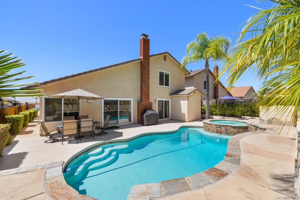 Tucked away at the end of a peaceful cul-de-sac on Stoneview Court, this charming 4-bedroom, 2.5 bath home offers the perfect balance of comfort, convenience, and California living. Step inside to a spacious floor plan filled with natural light, featuring a welcoming living room with a cozy fireplace — ideal for both lively gatherings and quiet evenings at home. The centrally located kitchen connects seamlessly to the dining area and opens to the expansive backyard, making entertaining effortless. The first-level primary suite provides comfort and privacy, creating a restful retreat. Outdoors, enjoy your very own sparkling pool surrounded by lush landscaping, with no neighbors behind — just tranquil views of protected nature. Whether you're hosting a summer barbecue or enjoying a peaceful morning coffee, this backyard sanctuary is designed for relaxation and play. Location Highlights: Situated in the highly desirable San Carlos neighborhood, this home is just minutes from Cowles Mountain where miles of hiking trails and breathtaking views await. Families will appreciate the top-rated schools nearby, including Ralph Dailard Elementary, Pershing Middle School, and Patrick Henry High School. Shopping, dining, and major freeways are all within easy reach, giving you quick access to the best of San Diego while still enjoying the peace of a quiet neighborhood. This is more than a home — it’s a lifestyle. With its sparkling pool, serene natural setting, and unbeatable location, this San Carlos gem offers the perfect opportunity to make every day feel like a retreat.