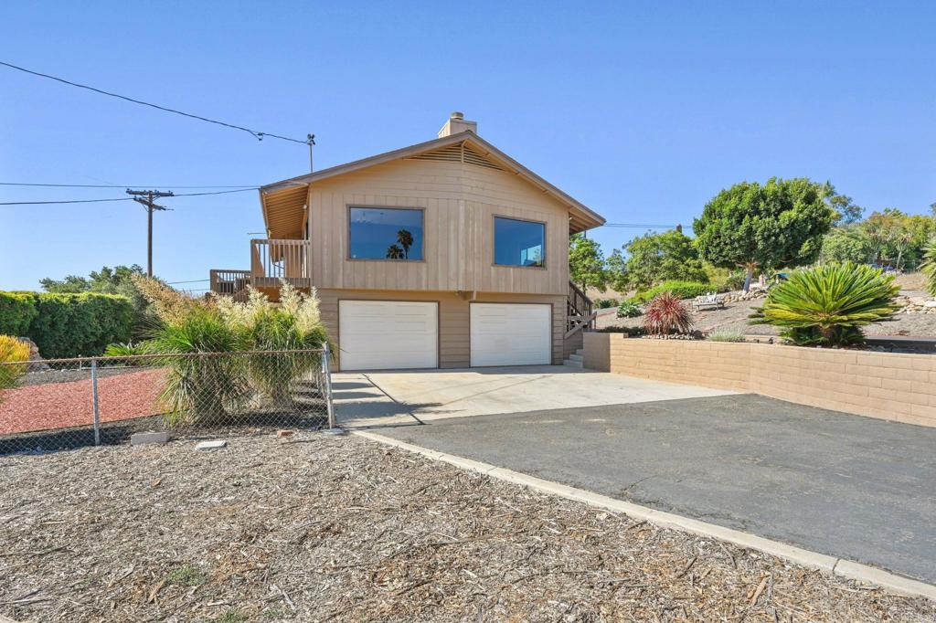 Experience breathtaking panoramic views from this lovingly maintained Vista Hills home, perched on just under an acre of private, usable land. With sweeping vistas in every direction—including ocean views and Catalina Island on a clear day—this one-of-a-kind property offers the best of SoCal living. Built with quality and care, this immaculate residence features 4 bedrooms and 3 bathrooms, with two bedrooms and a full bath on the lower level, ideal for multi-generational living, guest quarters, or potential rental income. The layout offers flexibility and space for your lifestyle to grow. Upstairs, enjoy a spacious kitchen with custom-built cabinetry and abundant counter space, flowing into a warm and inviting family room complete with a cozy fireplace. Step out from the primary suite onto a private deck and take in the serene landscape—perfect for morning coffee or sunset relaxation. The expansive exterior boasts ample parking with a two-car garage, plus space for 5+ additional vehicles, boat, or RV, and there’s even dedicated RV parking. The detached shed with electricity opens the door to endless possibilities—think workshop, studio, or home office. A tranquil fountain in the backyard, mature landscaping, and plenty of room to build an ADU or garden complete the outdoor experience. Septic and propane utilities help keep costs low, and there’s potential galore with this solid, well-cared-for home that may be a bit dated—but has been meticulously preserved by its original owner. Don’t miss this rare opportunity to own a slice of paradise with unmatched views, privacy, and potential.