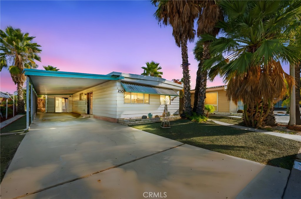 Welcome to Sierra Dawn Estates! Discover this beautifully refreshed 2-bedroom, 2-bath home situated on a spacious corner lot in one of Hemet’s most desirable 55+ communities. This move-in-ready residence features a recently renovated kitchen with sleek quartz countertops, modern cabinetry, and stylish finishes. The interior boasts new luxury vinyl plank flooring and fresh interior paint, creating a bright, modern feel throughout. Enjoy comfortable living spaces filled with natural light and a functional layout perfect for everyday living or entertaining. Additional highlights include washer and dryer hookups, a covered carport with parking for two vehicles, a large extended driveway, and a private backyard ideal for relaxing or outdoor gatherings. Residents of Sierra Dawn Estates enjoy access to multiple clubhouses, swimming pools, a spa, fitness center, and a full calendar of social activities, all within a friendly, well-maintained community. Move-in ready, beautifully updated, and set on a larger corner lot with a private backyard and extended driveway — this home is a must see!