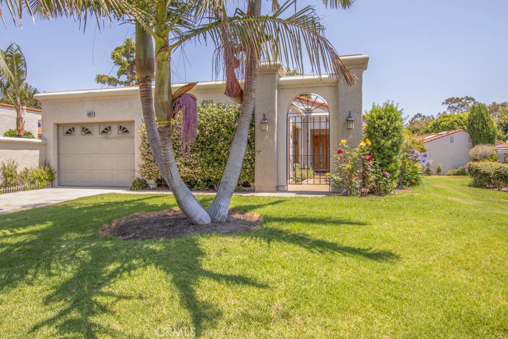 Welcome to 5521-C Via La Mesa – a beautiful remodeled two-bedroom, two-bath, single-level, end-unit VILLA FRANCESCA residence in an idyllic setting in the Laguna Woods senior community. With excellent curb appeal, the entry to this residence will surely impress visitors with its immaculate tasteful landscaping. Visitors are greeted by a lovely custom front door with attractive etched glass inserts. This popular floorplan offers twin primary suites with a large central living room. The spacious living room features a high ceiling, solar tube and direct access to the enclosed rear sunroom. (Both of the bedrooms also have direct access). The remodeled kitchen is simply stunning, featuring attractive wood cabinetry with soft-close drawers, separate trash/recycling drawer, pots and pans drawer, granite countertops with gorgeous tile backsplash, stainless steel appliances and large skylights. Custom closets in both bedrooms provide ample storage. Both baths have skylights as well as marble countertops and oversized showers with seats, grab bars and convenient accessory shelves. Upgrades throughout the residence include smooth ceilings, crown molding and baseboards, recessed lighting, dual-pane windows and beautiful walnut flooring. Ceiling fans can be found in the living room, both bedrooms and the front and rear patios. The large covered front courtyard provides the perfect space for year-round all-weather entertaining, dining and relaxing. There is even room in this covered courtyard to store a golf cart. The enormous enclosed and covered rear sunroom (measuring approximately 250 sq. ft.) gets the early morning sun and has multiple skylights and boasts a gorgeous outlook with a view of endless greenbelt and trees stretching into the distance. This sunroom is a versatile living space that could serve as a workout area, arts and crafts studio or simply a comfortable bonus room perfect for relaxing and taking in the view. A small open patio sits just off the enclosed rear sunroom. The single-car garage has washer-dryer hookups, utility sink, cabinet storage and direct access into the residence via a service door into the kitchen. The driveway can accommodate an additional vehicle and there is ample street parking for guests. Do not miss this spectacular home!