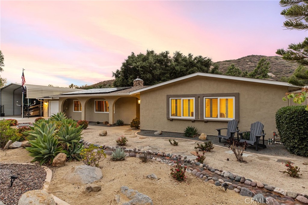 Incredible single-story home on a fully fenced private lot with no rear neighbors! This amazing home offers the perfect blend of comfort, functionality, and space to live your dream lifestyle. Featuring an open layout with 3 bedrooms and 2 bathrooms, the heart of the home is a beautifully designed kitchen boasting rich cabinetry, a large center island, ample storage, and a seamless flow into the family room—complete with a cozy wood-burning fireplace. Enjoy peaceful views from the front porch and entertain in the backyard oasis complete with a built-in BBQ/Outdoor Kitchen, patio seating, and low-maintenance landscaping. The oversized lot includes 2 RV-covered parking structures - Upper (40’10”x25’), Lower (26’4”x11’7”) - with cleanout hookup, and a 30'x19' Quonset workshop with electric and water. The attached 2-car garage has epoxy floors and generous in size. Upgrades include 26 fully owned solar panels, new AC, and a newer roof installed in 2019. Stop paying for storage and enjoy this beautiful home with plenty of room for boats, RVs, and a future ADU or expansion. Great location close to freeway access and top-rated schools. Don’t miss this unique opportunity to own land, space, and privacy all in one!