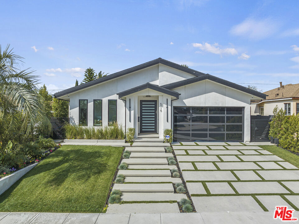 Introducing North Hollywood's latest gem, a stunning modern home situated just moments away from the bustling studios, the NoHo Arts District, and the brand-new NoHo West shopping center. With its contemporary design and abundance of modern amenities, this newly developed home is a true statement-maker. As you step inside, you'll immediately notice the airy open floor plan with high ceilings and a plethora of smart home features. The main living space is expansive and boasts impressive 15ft vaulted ceilings that create a grand ambiance. The designer chef's kitchen is a masterpiece, featuring high-end Bertazzoni appliances, a massive center island with a butcher block slab, and built-in features like an integrated pet bowl, paper towel holder, and a drawer microwave. The family room is the perfect spot to relax and unwind, with a beautiful fireplace and pocketing glass doors that create a seamless indoor/outdoor living experience. Step outside, and you'll find a heated pool and spa, as well as a covered outdoor kitchen complete with a BBQ, sink, and mini-fridge. The luxurious primary suite is a true sanctuary, featuring cathedral ceilings, a spacious walk-in closet, and a sumptuous bathroom with a lavish soaking tub. There are also two additional ensuite bedrooms with walk-in closets, a fourth bedroom/office, a custom wine rack, LED-lit mirrors in every bathroom, and a laundry room. The home also boasts a dog run, a two-car garage, and a built-in home speaker system. This exceptional modern home in North Hollywood is an absolute must-see, offering unparalleled luxury and convenience in a prime location.