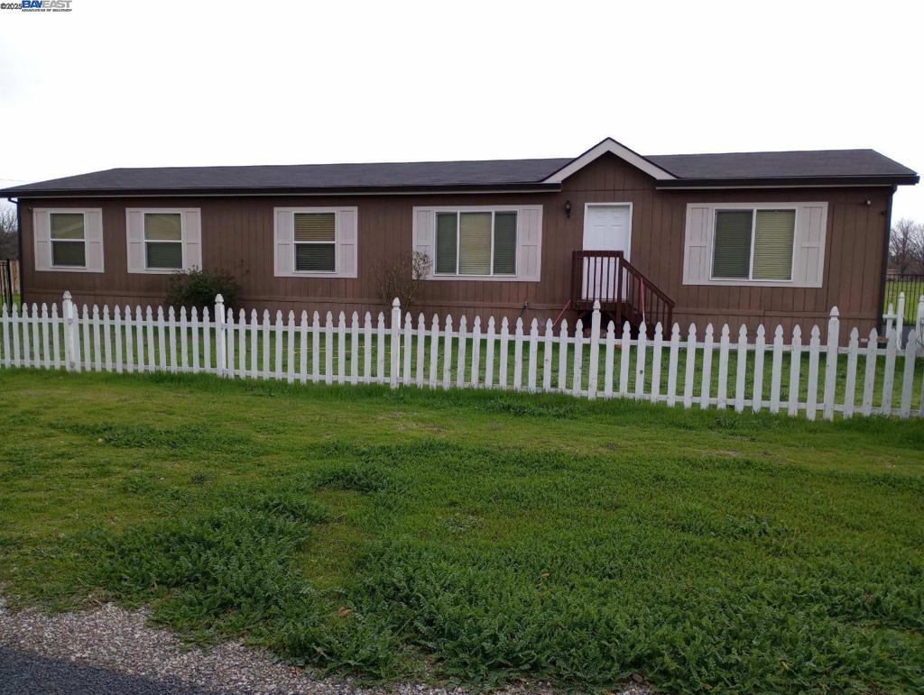 Spacious country living on 2 usable acres! This 4-bedroom, 2-bath 2014 manufactured home offers 1,867 sq ft of well-laid-out living space with an open floor plan, vaulted ceilings, and abundant natural light. The home features a large kitchen with island seating, dining area, and a generous living room—perfect for gatherings. Primary suite includes a walk-in closet and private bath with soaking tub and separate shower. Property is fenced and cross-fenced, ideal for animals or agriculture, and includes a seasonal creek, outbuildings, and ample parking. Enjoy peaceful rural surroundings while still being just minutes from downtown Orland, Hwy 32, and I-5. Zoned AE-20—check with Glenn County for potential ag or hobby farm use!