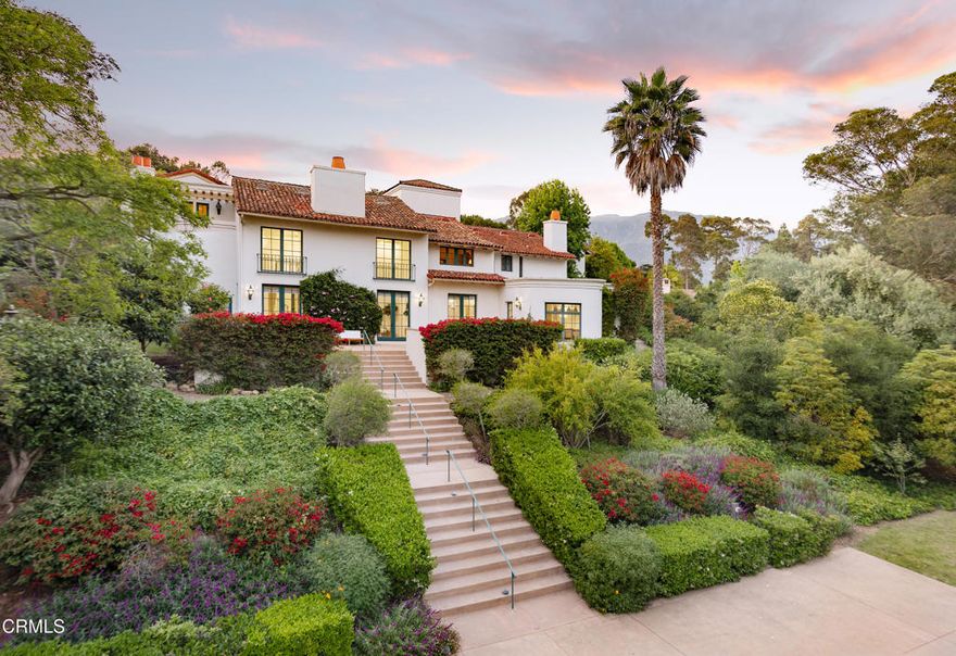 Tucked behind the gates of Montecito's coveted Ennisbrook community, 284 Gould Lane is a grand Mediterranean residence blending timeless architecture with privacy and scale. Set amid vibrant gardens on 1.68+/- acres, this expansive estate captures the romance of Santa Barbara's golden age with its classic clay tile roof and wrought iron detailing. A dramatic formal entry introduces the voluminous interiors, where a soaring great room with a stone fireplace and oversized windows offers an elegant focal point for gathering. Just beyond, the formal dining room opens to a sun-drenched terrace, ideal for indoor-outdoor entertaining. The spacious kitchen includes a charming breakfast nook and bar seating, with windows that overlook the beautiful pool and spa, creating a serene backdrop for everyday living. The bedrooms provide generous accommodations, including a primary suite with fireplace, sitting area, and peaceful views. A separate guest suite above the garage, complete with its own entrance and full bath, offers added privacy for visitors or extended stays. Multiple living spaces - including an office and cozy den with a fireplace and a flexible upstairs landing - ensure room for both relaxation and entertaining. Outside, meandering paths wind through colorful plantings, mature trees, and blooming bougainvillea. Multiple patios offer peaceful settings for al fresco dining, while the motor court and three-car garage provide ample parking and storage. Located within the highly desired Ennisbrook enclave, this residence enjoys access to community amenities including tennis courts, pool, clubhouse, scenic trails, and security. An exceptional opportunity to experience the Montecito lifestyle in a gated setting just moments from beaches, shops, and the Upper & Lower Village.