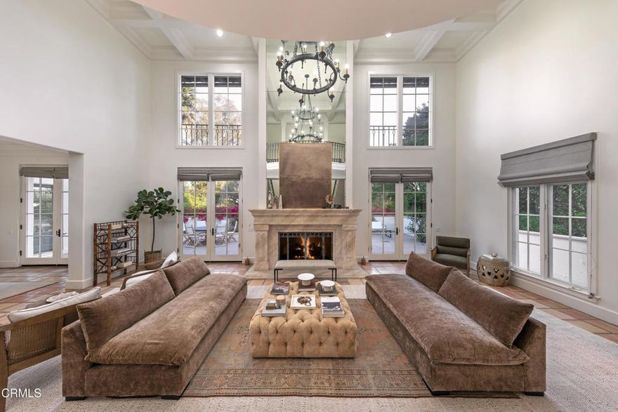 Tucked behind the gates of Montecito's coveted Ennisbrook community, 284 Gould Lane is a grand Mediterranean residence blending timeless architecture with privacy and scale. Set amid vibrant gardens on 1.68+/- acres, this expansive estate captures the romance of Santa Barbara's golden age with its classic clay tile roof and wrought iron detailing. A dramatic formal entry introduces the voluminous interiors, where a soaring great room with a stone fireplace and oversized windows offers an elegant focal point for gathering. Just beyond, the formal dining room opens to a sun-drenched terrace, ideal for indoor-outdoor entertaining. The spacious kitchen includes a charming breakfast nook and bar seating, with windows that overlook the beautiful pool and spa, creating a serene backdrop for everyday living. The bedrooms provide generous accommodations, including a primary suite with fireplace, sitting area, and peaceful views. A separate guest suite above the garage, complete with its own entrance and full bath, offers added privacy for visitors or extended stays. Multiple living spaces - including an office and cozy den with a fireplace and a flexible upstairs landing - ensure room for both relaxation and entertaining. Outside, meandering paths wind through colorful plantings, mature trees, and blooming bougainvillea. Multiple patios offer peaceful settings for al fresco dining, while the motor court and three-car garage provide ample parking and storage. Located within the highly desired Ennisbrook enclave, this residence enjoys access to community amenities including tennis courts, pool, clubhouse, scenic trails, and security. An exceptional opportunity to experience the Montecito lifestyle in a gated setting just moments from beaches, shops, and the Upper & Lower Village.