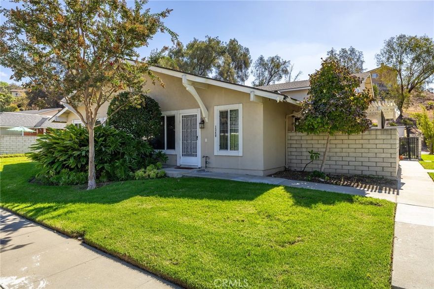 Charming Single-Story Townhome in the Desirable Woodside Community of West Covina. Located in the sought-after Woodside Townhomes, this single-story residence offers comfort, privacy, and convenience all in one. Great curb appeal is highlighted by a lush green lawn, a privacy hedge between neighbors, and a planter lining the walkway to the front door. Step inside to a spacious family room with tiled flooring and a large front-facing window that fills the space with natural light. The updated kitchen features crisp white cabinetry, granite countertops, a full tile backsplash, and stainless steel appliances—perfect for everyday living or entertaining. This home offers two well-sized bedrooms, a full hall bathroom with a shower/tub combo and sliding glass enclosure, and a dedicated indoor laundry room for added convenience. Enjoy private outdoor living in the fully enclosed backyard, featuring a covered patio, block wall fencing, and low-maintenance concrete decking—ideal for relaxing or hosting guests. As a resident of the Woodside community, you’ll have access to resort-style amenities including a swimming pool, playground, basketball court, and expansive grassy park areas.