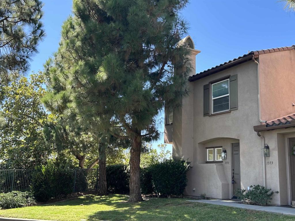 Rarely available prime location on the rim, with one of the largest patios and outdoor space in the complex. It feels like a single family residence. Freshly painted with new carpet throughout. It is turn-key ready to move in. The kitchen has a gas stove, large pantry, lots of cabinet and counter space. The refrigerator, washer and dryer are included. And don't miss the huge closet with extra storage under the stairs. Ceramic tile flooring extends from the kitchen into the dining room, while the living room has plush new carpet, recessed lighting, and a gas fireplace. The spacious primary bedroom includes a walk-in closet, separate shower and tub, ceiling fan and a fabulous view all the way to the ocean! Two additional bedrooms and a bath are also upstairs. Also features a 2-car attached garage, and central A/C. Located in the gated community of Westridge at San Elijo, this is an end unit with mountain views, next to an open green space with pine trees for added privacy, and lots of guest parking. The Westridge community provides a resort-like pool and spa area complete with a stunning water feature. There is also easy access to 18 miles of maintained trails, parks, playgrounds, ball fields, dog park, and top-rated schools. In addition, the popular Town Center offers shops, a grocery store and a selection of restaurants.