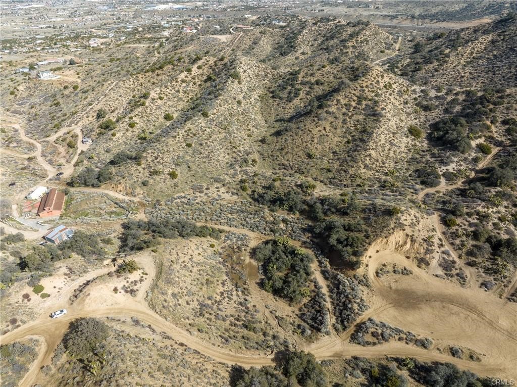 High up in the hills of Pinon Hills with beautiful views of the valley to the north and the San Gabriel Mountains to the south. This is where the desert meets the mountains at approximately 4,800 feet of elevation. This is 4 contiguous lots that are listed for sale together that all add up to approximately 16.99 +/- acres of adjoining land. The parcels included in this listing are 3036-241-03, 2026-241-05, 3036-241-06, and 3036-241-19. These parcels will need to establish their own water service by either a main line extension through PPHCSD or potentially a private well. Buyer to verify availability and access to utilities.